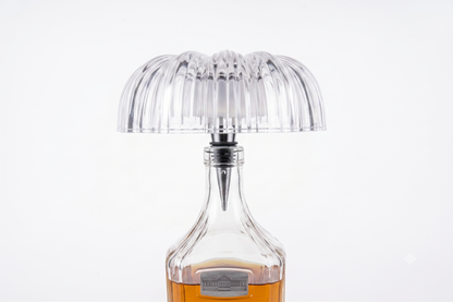 Clear ribbed dome-shaped bottle-top lamp fitted to a glass bottle